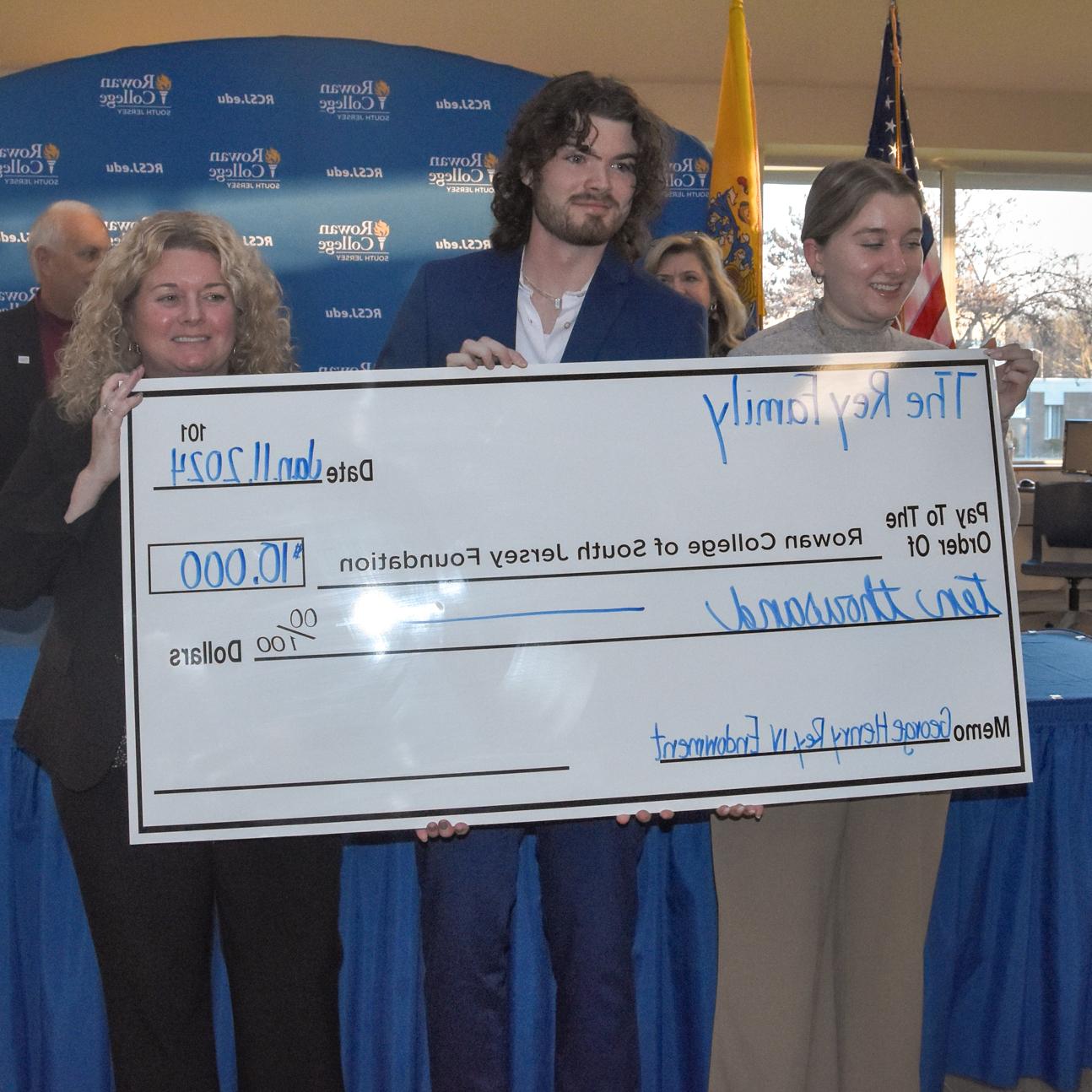 Mrs. Julia Elizabeth “Beth” Rey (far right) and her children, Makenzie Rey and George Rey, V, announce the creation of the Georg